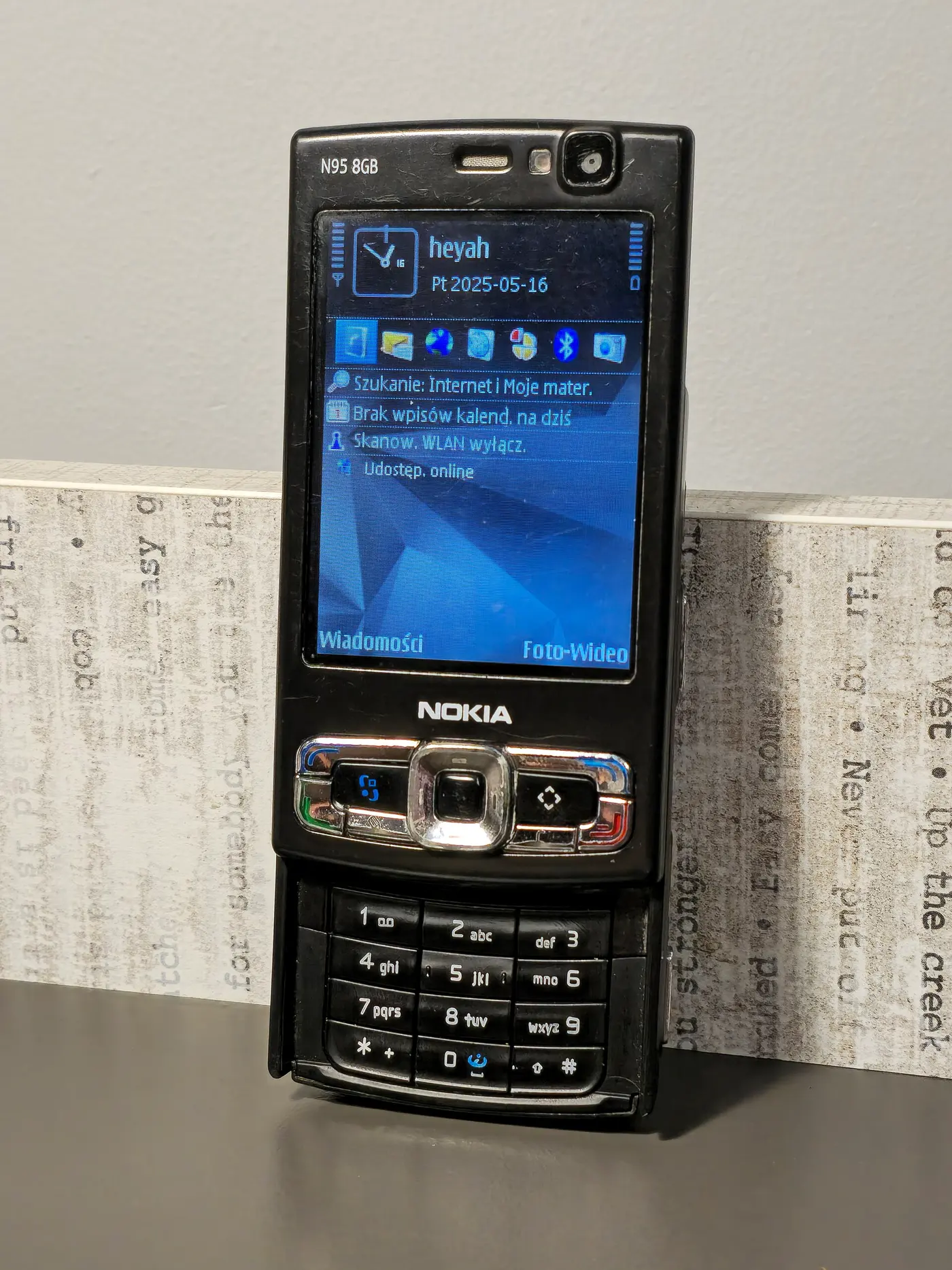 A black Nokia N95 mobile phone, slid open