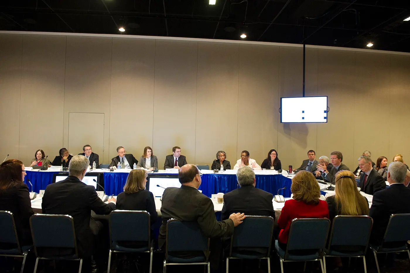 A performance review meeting around a U-shaped table